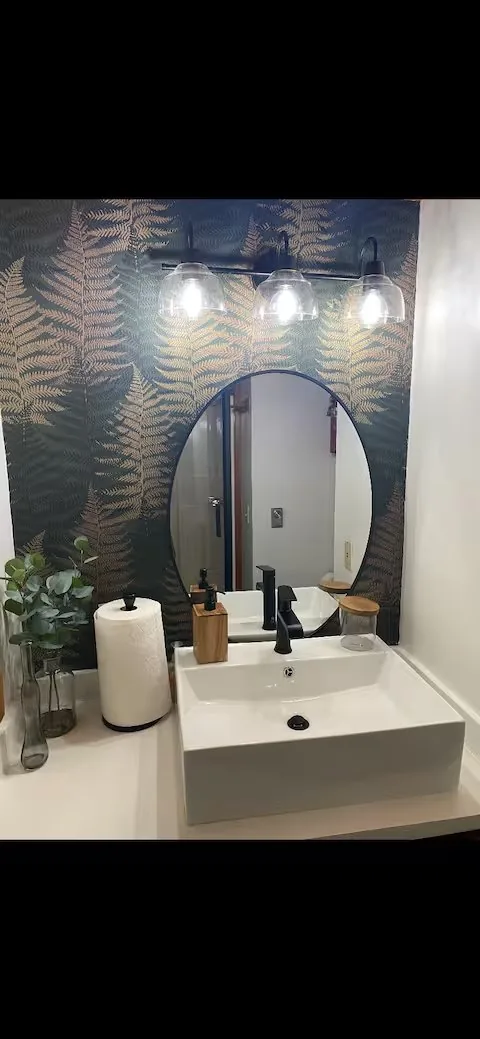 The cabin's fern-wallpaper bathroom — the kind of detail that takes a few hours of antique-shopping in Honesdale to source