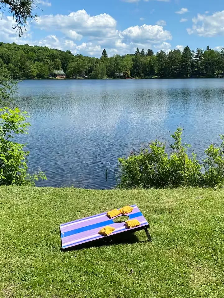 Lawn games and lake views from the cabin grounds — most evenings end here, after a 15-minute drive back from Hancock NY restaurants