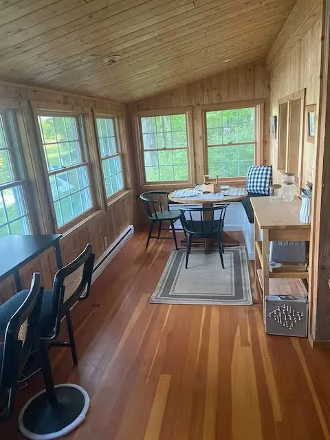 The cabin's screened-in dining porch — where you'll end up after a Honesdale day, eating something simpler
