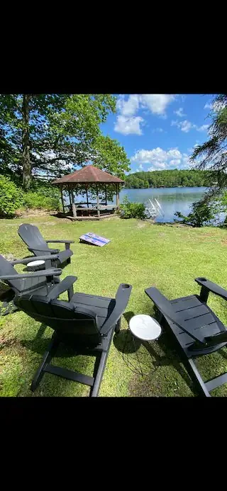 Adirondack chairs by Shehawken Lake — what fly-fishing partners do at the cabin while their angler is on the river