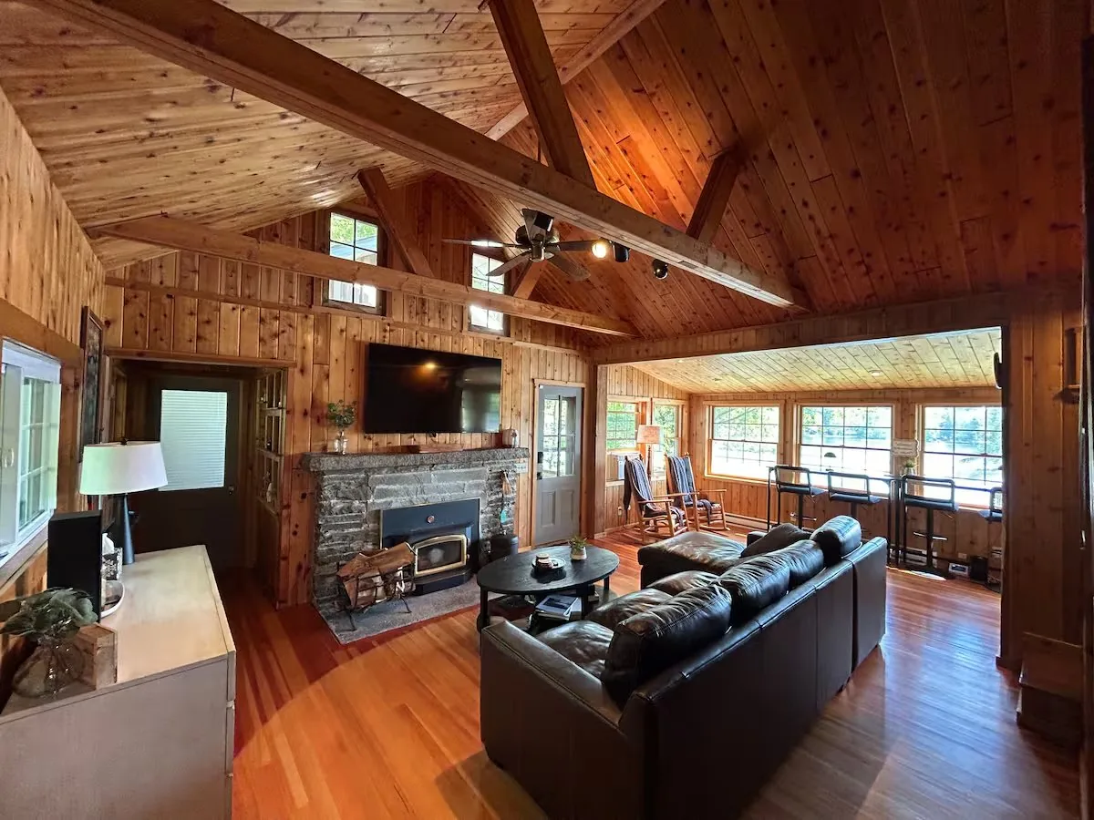 Cathedral-ceiling great room with stone fireplace at the cabin — where Elk Mountain ski weekends end up after the lifts close at 4pm