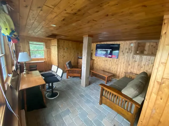 The cabin's walk-out basement seating area — a typical Wayne County rainy-day spot, but most days you're outside doing something on this list